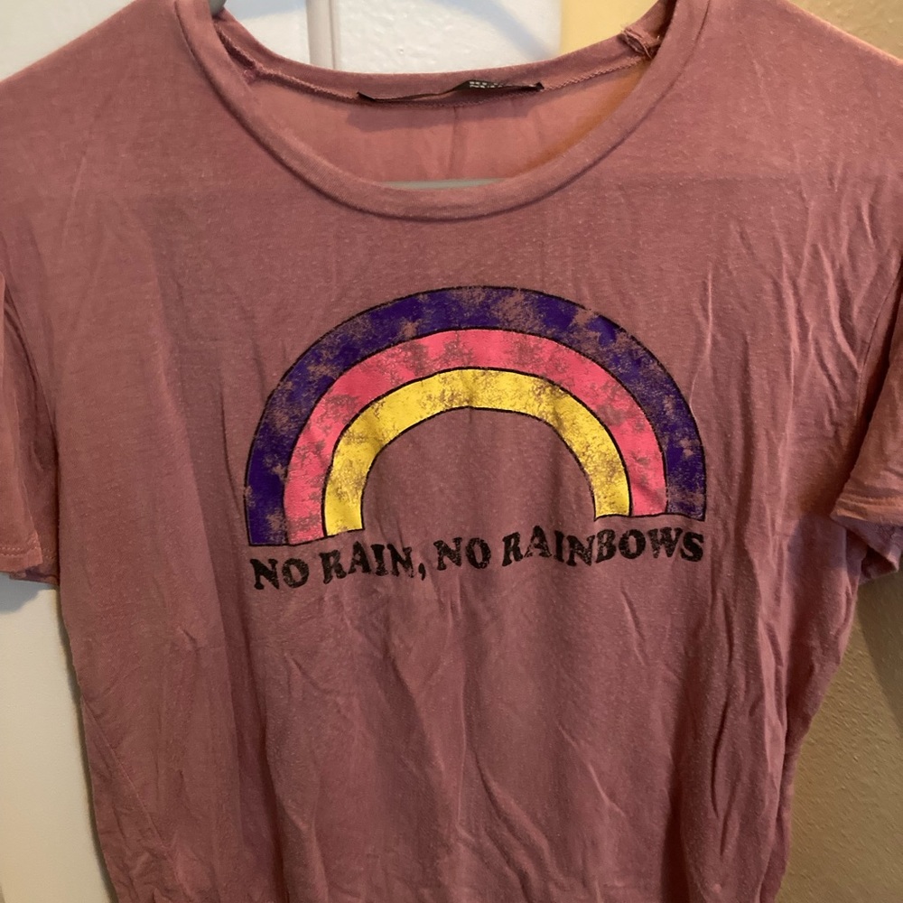 Pink crop top with a rainbow on front and says “No rain, no rainbows”